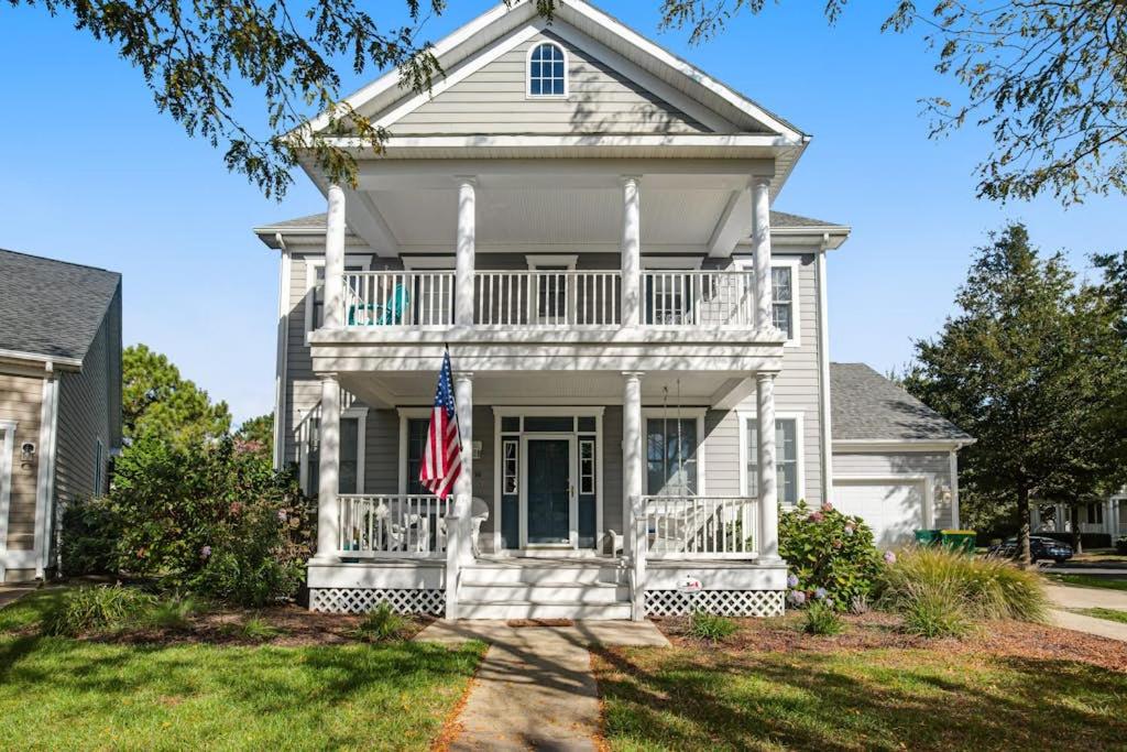 a white house with an american flag in front of it at Bear Trap Dunes - 96 Willow Oak in Ocean View