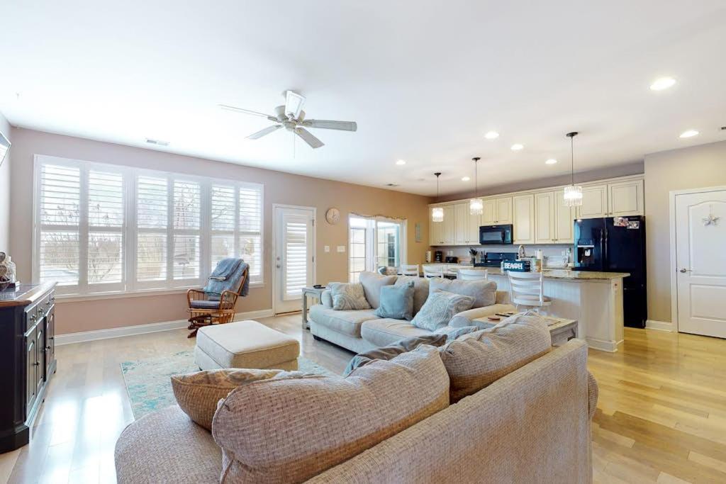 a living room with a couch and a kitchen at Bishops Landing -- 16985 Bellevue in Millville