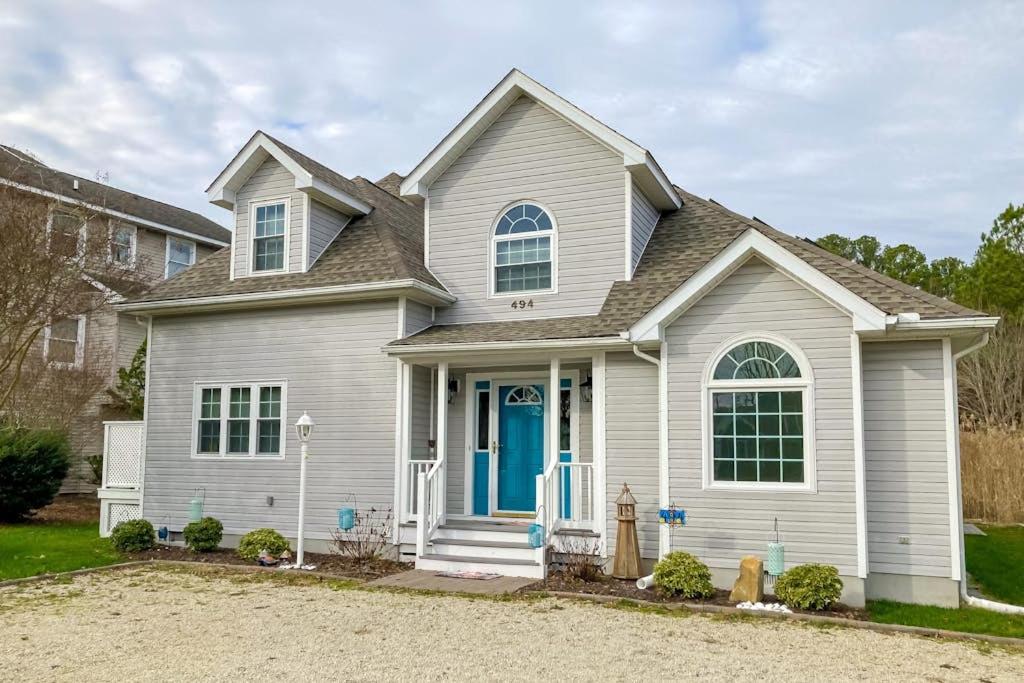 a white house with a blue door at Salt Pond --- 494 Bethany Loop in Bethany Beach