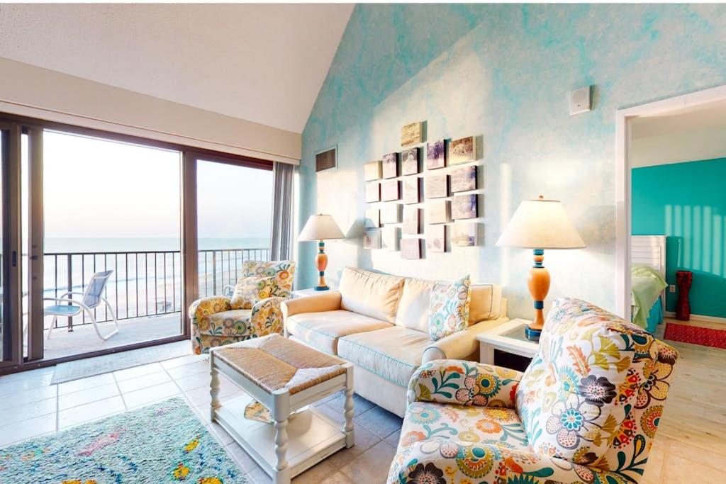 a living room with a couch and chairs and a balcony at Sea Colony - 904 Dover House Rd in Bethany Beach
