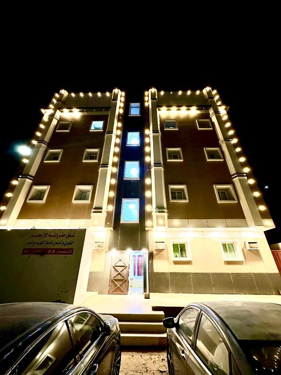 a large building with lights on it at night at شقق ابو طلال المفروشة in Sakakah