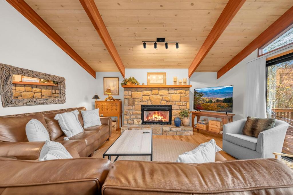 a living room with a couch and a fireplace at Heavens Door in Beech Mountain