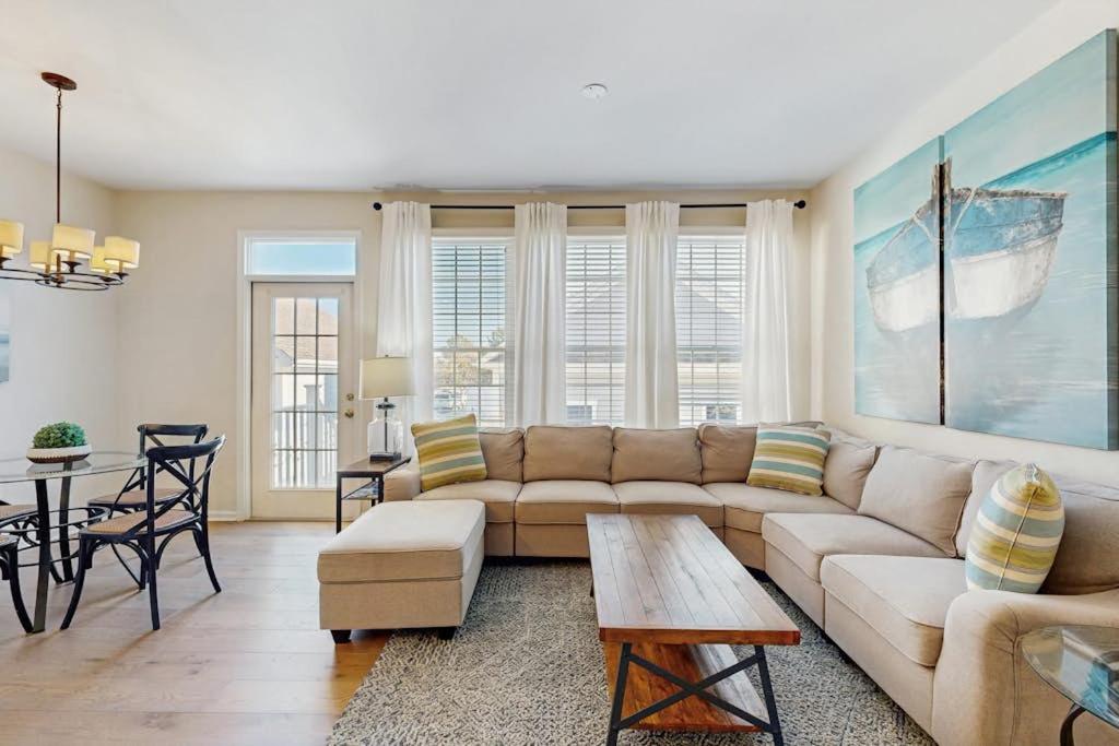 a living room with a couch and a table at Bear Trap Dunes -- 13 Village Green in Ocean View