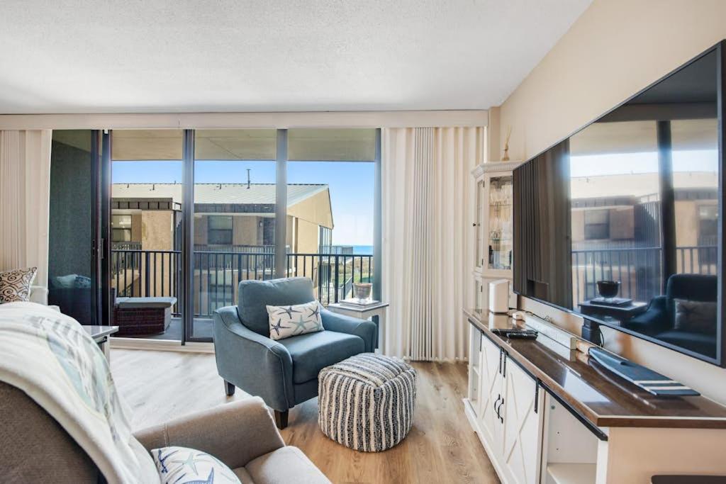 a living room with a couch and a chair and a television at Sea Colony --- 208 Brandywine House in Bethany Beach