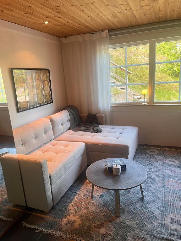 a living room with a couch and a table at Gästhus med båtplats in Kvicksund