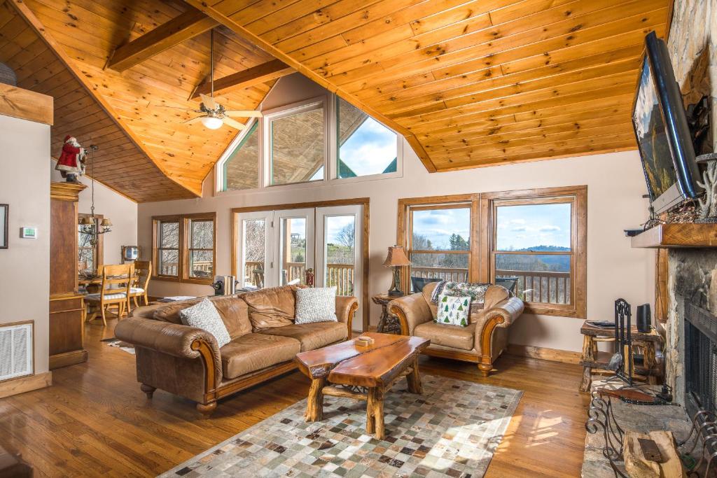 a living room with couches and a fireplace at Serenity in Blowing Rock