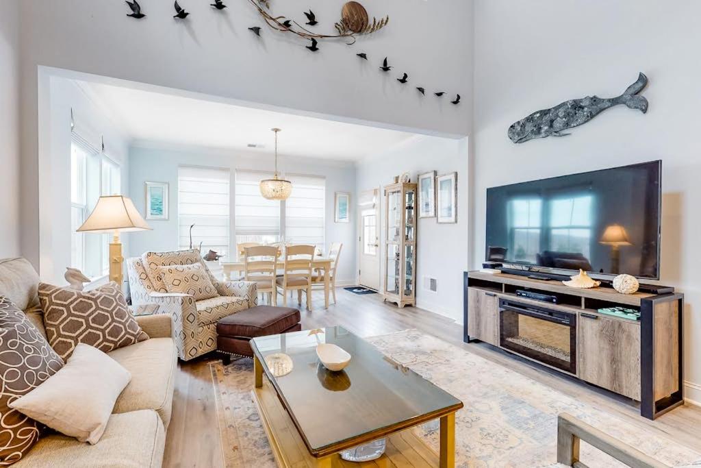 a living room with a couch and a tv at Bayside Resort - 28031 Sea Dock in Selbyville