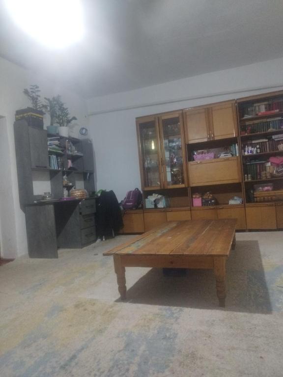 a living room with a wooden table in the middle at Алима in Ottuk