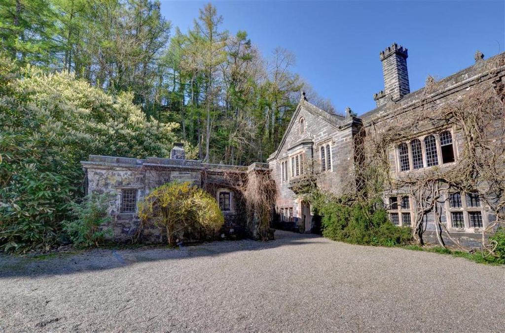 an old stone house with a driveway in front of it at 1 Bed in Llanrwst oc-wag232 in Llanrwst