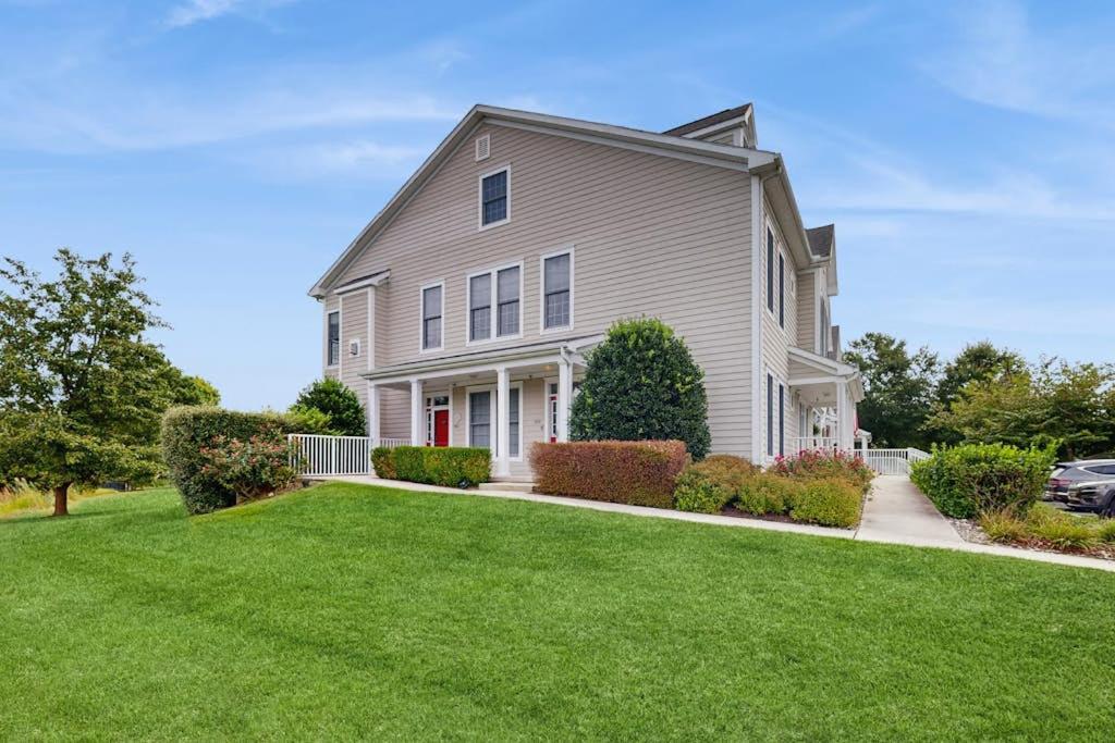 a large white house with a green lawn at Bear Trap Dunes --- 124 October Glory Ave Unit #B in Ocean View