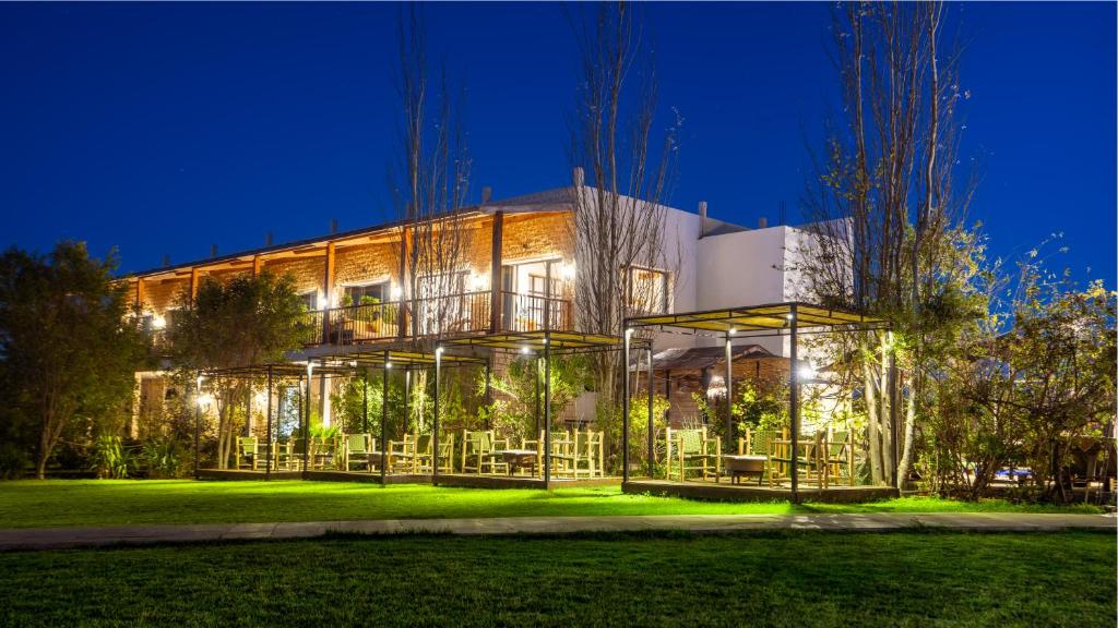 a large building with a lot of windows at night at Bio et Bois -Luxury Bio Farm- in Moulay Yacoub