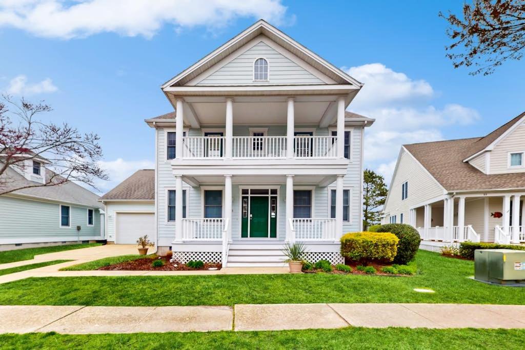 a white house with a green door at Bear Trap Dunes - 53 October Glory Ave in Ocean View