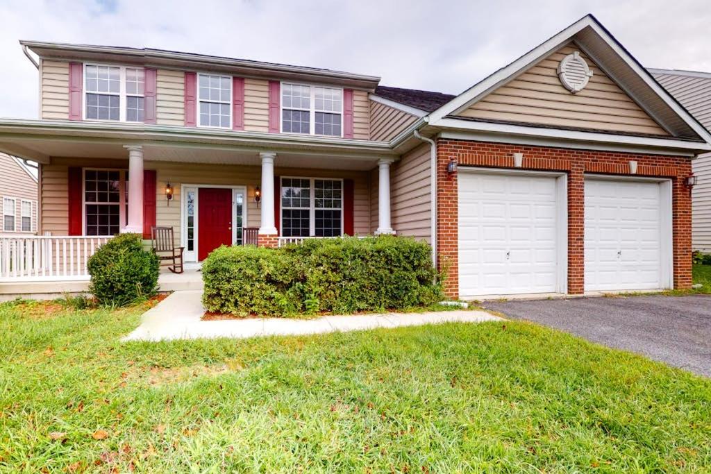 a house with two garage doors in a yard at Wedgefield - 7 Saint George in Ocean View