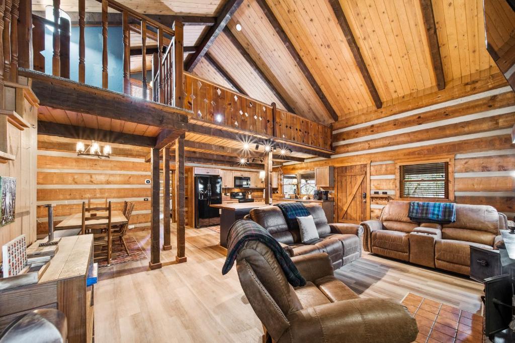 a living room with wooden walls and furniture in a cabin at Creekside Cabin in Blowing Rock