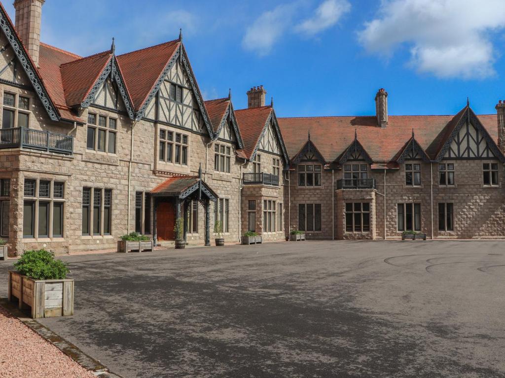 a large brick building with a lot of windows at Macdui - Mar Lodge Estate in Ballater