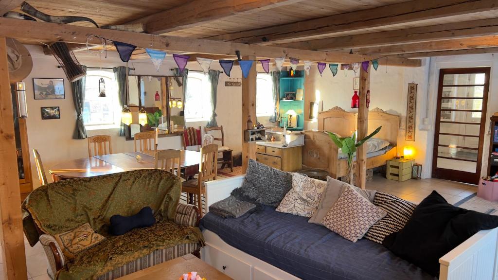 a living room with a couch and a dining room at SommerHuset in Samsø