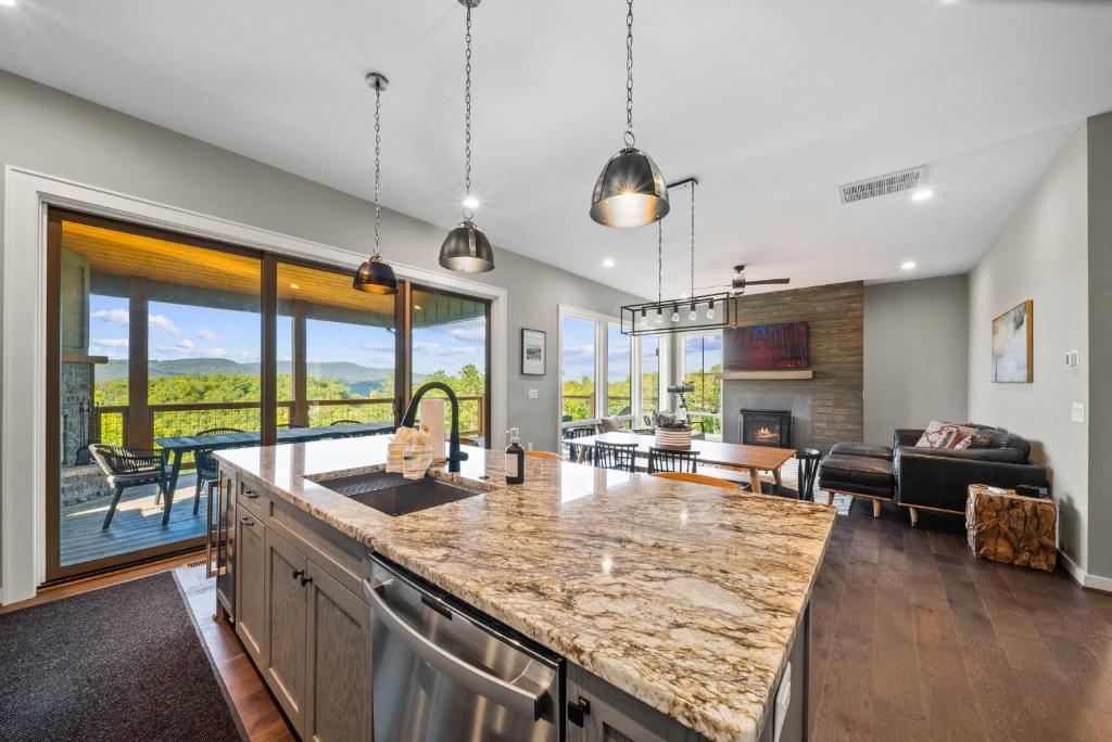 a kitchen and living room with a view of a couch at Majestic Meadows in Boone