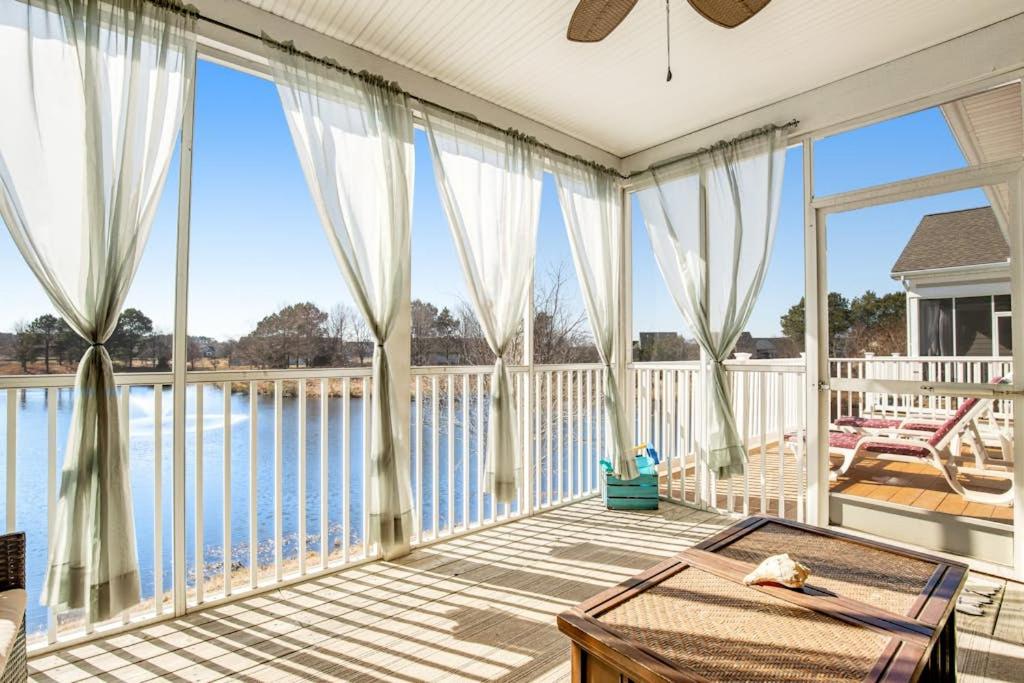 a large screened porch with a view of the water at Bear Trap Dunes - 60F October Glory in Ocean View