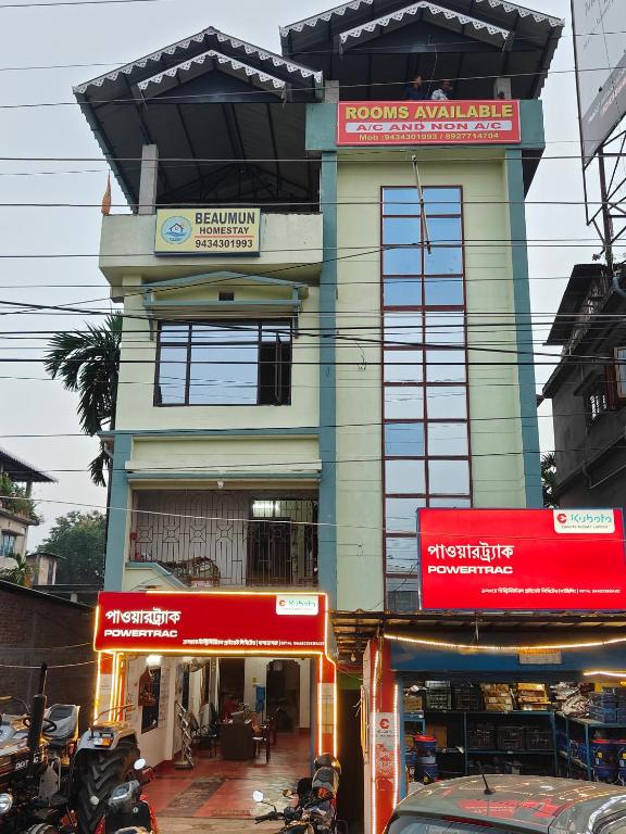 a building with signs on the side of it at Beaumun Homestay in Bāghdogra