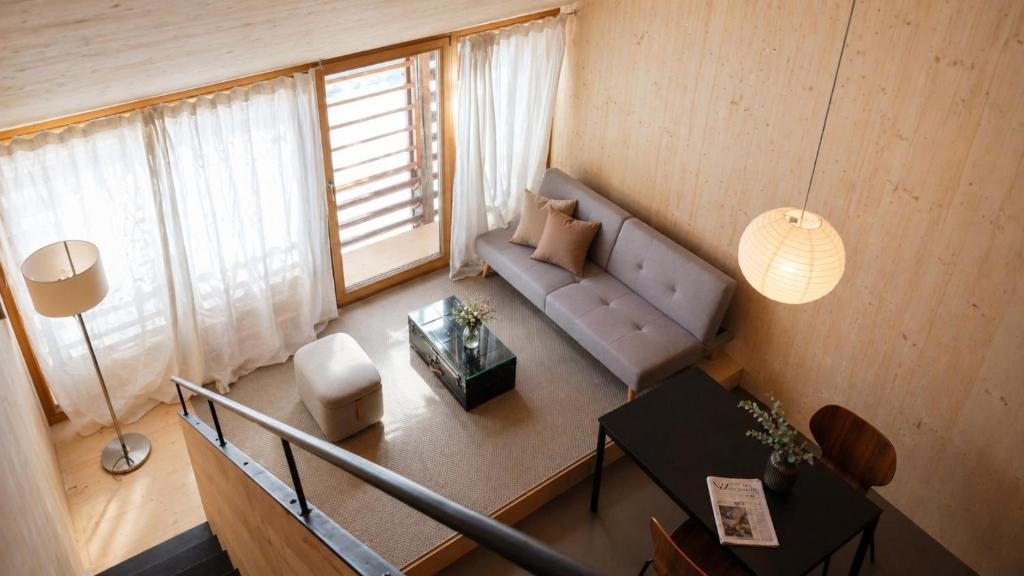 a living room with a couch and a table at Union Lodge Fabrik in Bern