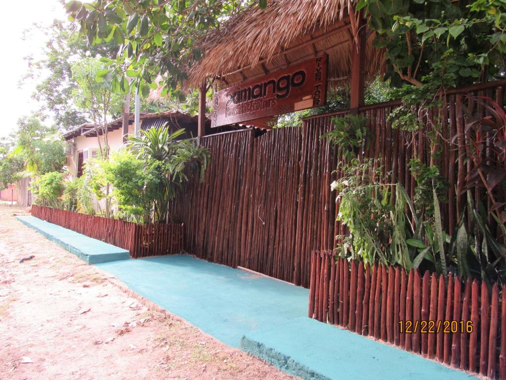 a building with a fence and a sign on it at Pousada Ximango de Alter do Chão in Alter do Chao