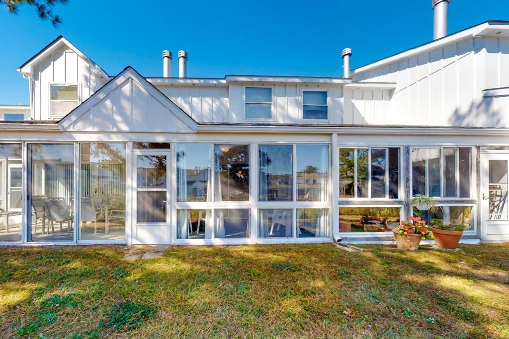 a large white house with large sliding glass doors at Mallard Lakes -- 38243 Cardinal #115 in Selbyville