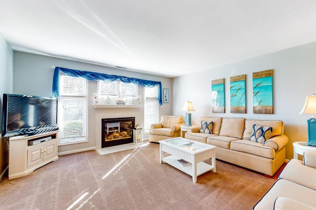 a living room with a couch and a tv at Sea Colony - 56184 Pine Branch Way in Bethany Beach