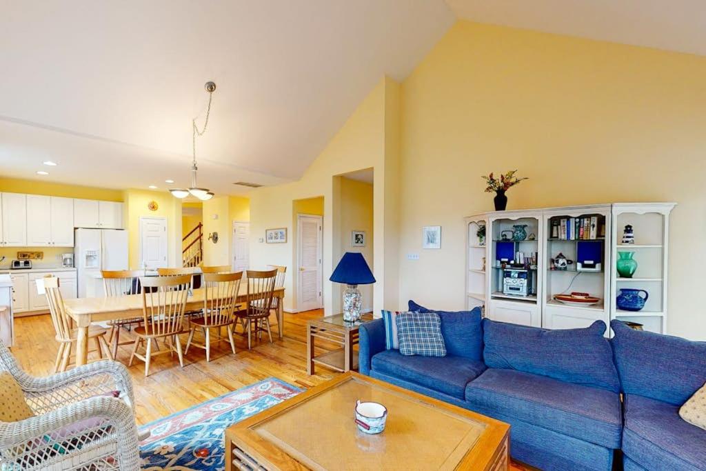 a living room with a blue couch and a table at Bear Trap Dunes - 2 October Glory in Ocean View