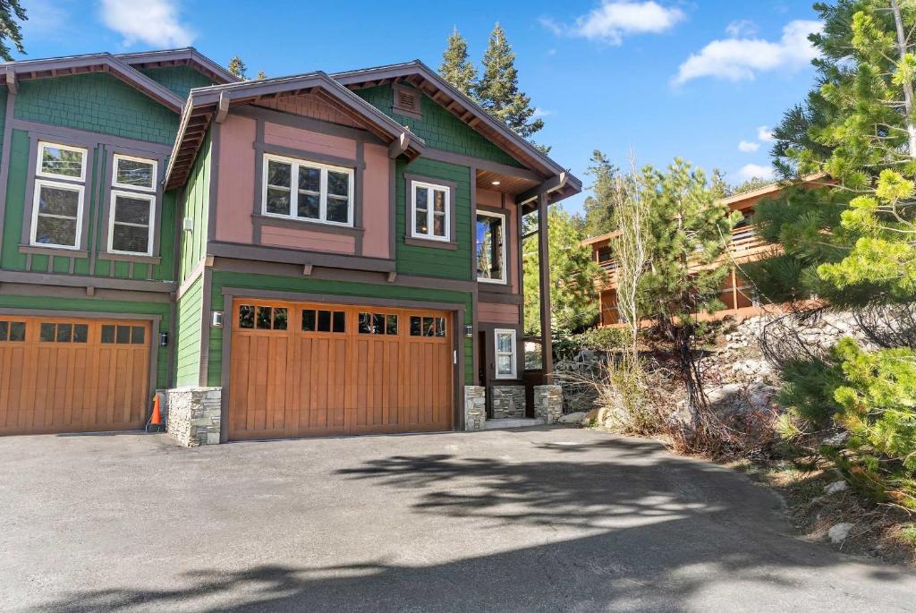 a green and pink house with a garage at 4BR Townhome Near Canyon Lodge & Lakes Basin in Mammoth Lakes