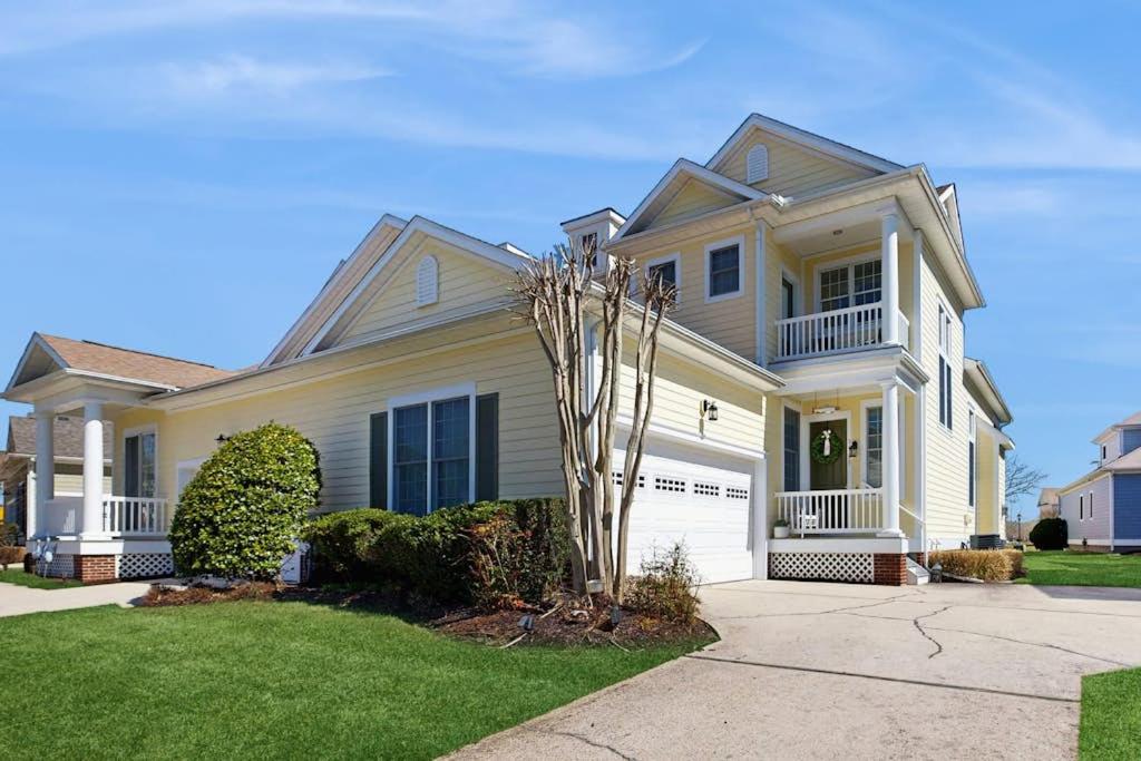 a white house with a tree in the front yard at Bayside Resort - 36295 Sunflower in Selbyville