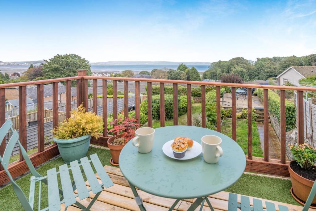 a table with a plate of food on a balcony at 3 Bed in Mumbles oc-m33090 in The Mumbles
