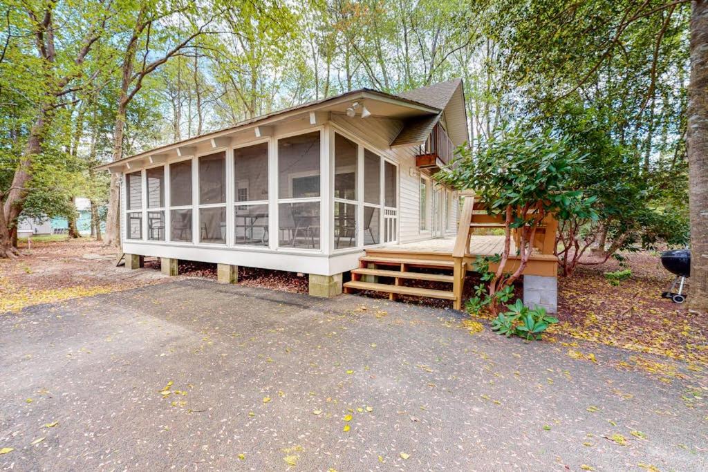 a small house with a porch and a driveway at Bethany West - 609 Brookview in Bethany Beach