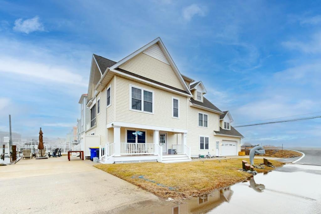 a white house with the ocean in the background at West Fenwick --- 39110 Van Buren Ave in Selbyville
