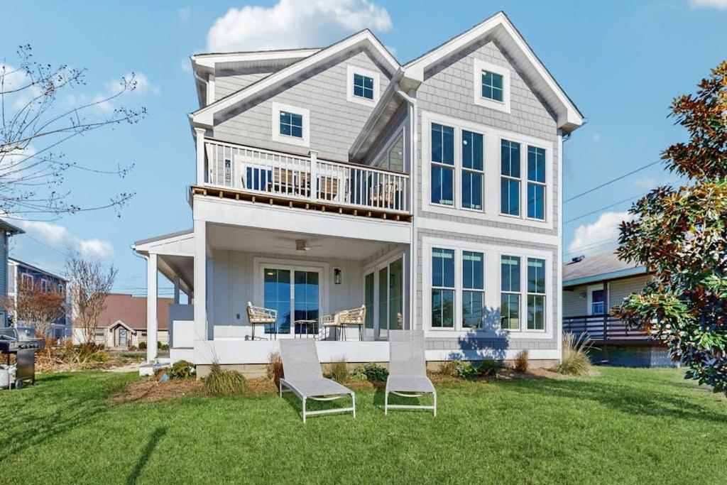 a large white house with two chairs on the lawn at South Bethany --- 102 Brandywine Dr in Bethany Beach