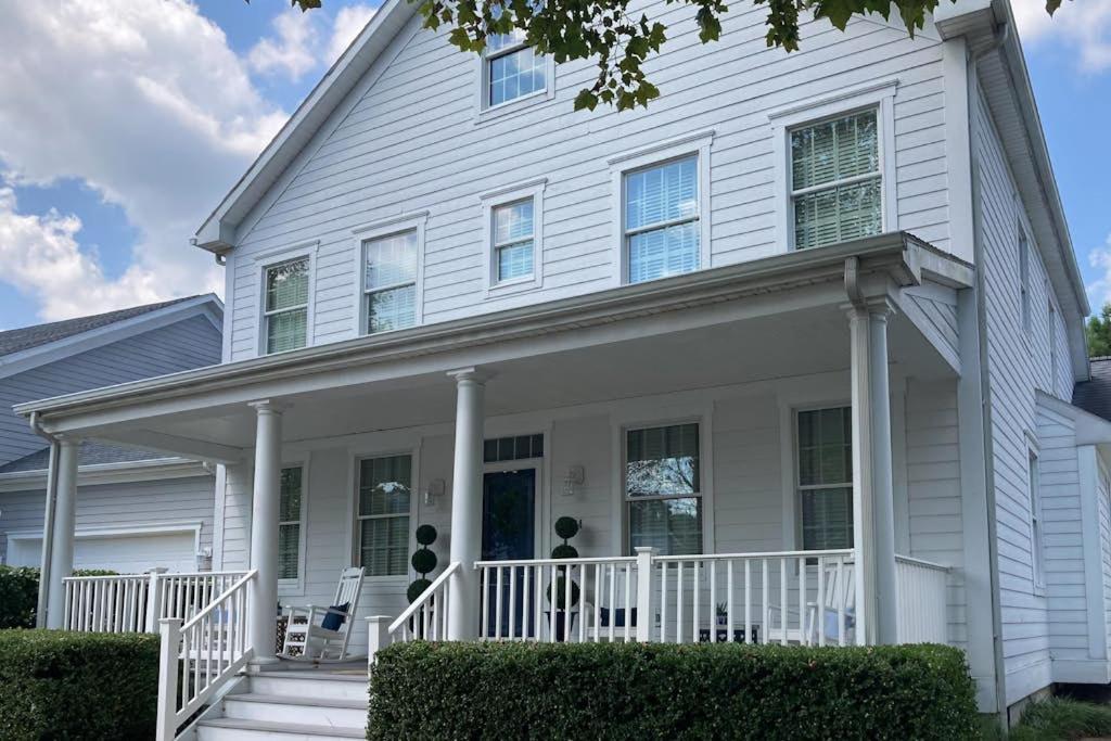 a white house with a white porch and columns at Bear Trap Dunes --- 34 Sycamore Street in Ocean View