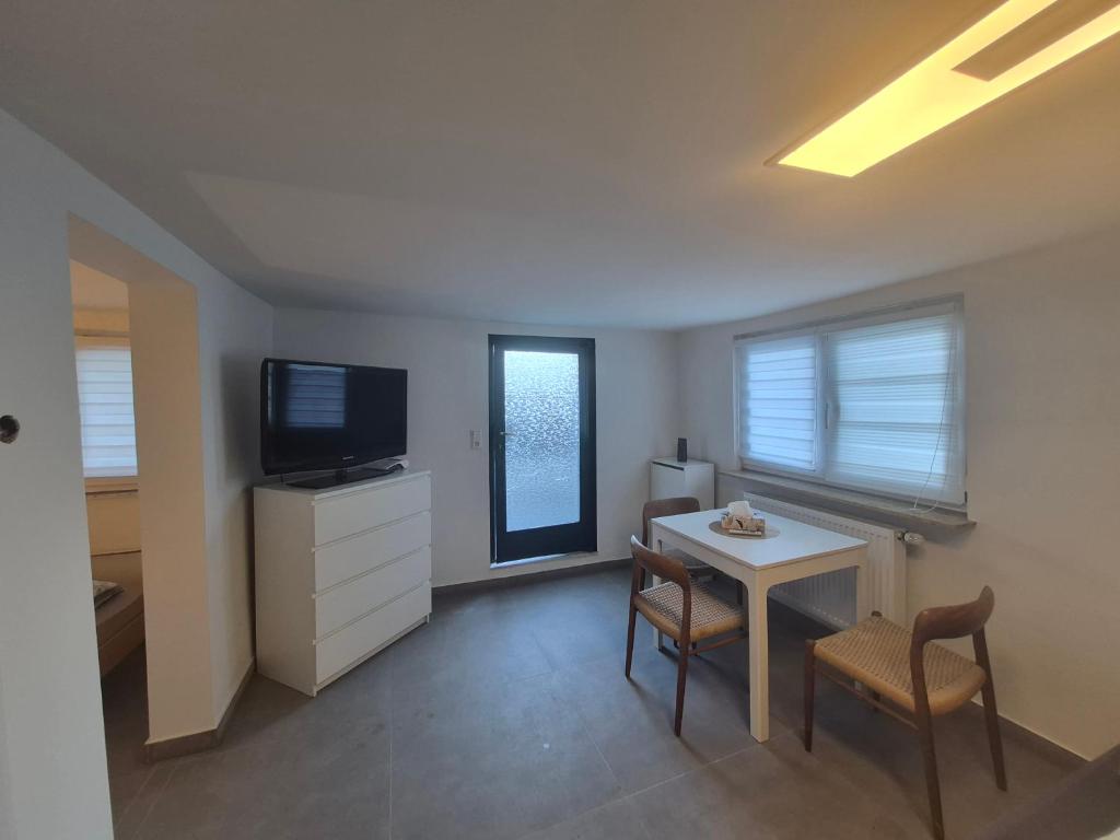 a living room with a small table and a television at Nektarios Apartments in Kernen