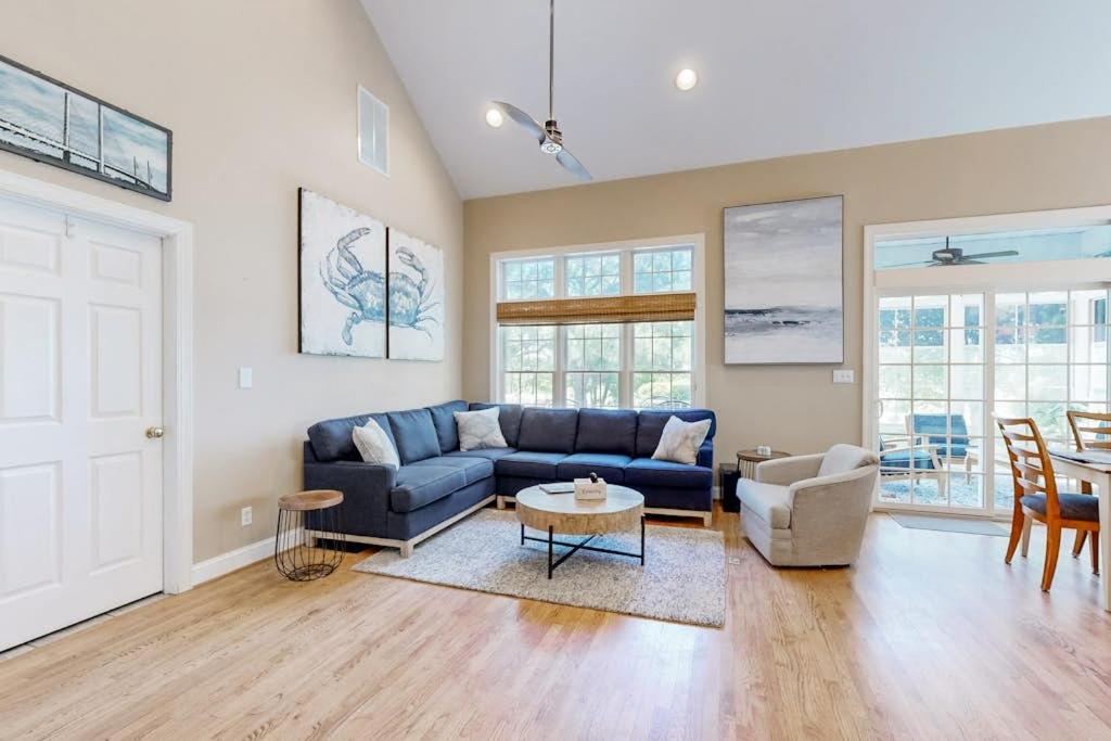 a living room with a blue couch and a table at Bear Trap Dunes - 67 Willow Oak in Ocean View