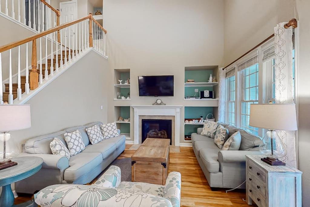 a living room with a couch and a fireplace at Bear Trap Dunes - 91 Willow Oak in Ocean View