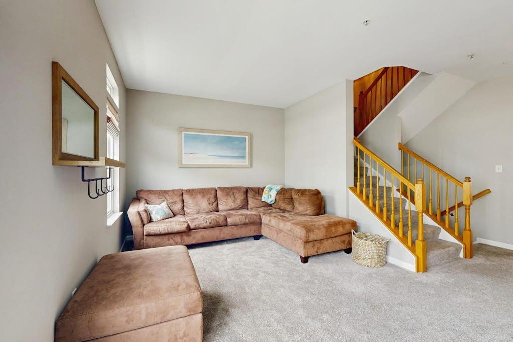 a living room with a couch and a staircase at South Hampton --- 38118 E Chester Ln in Ocean View