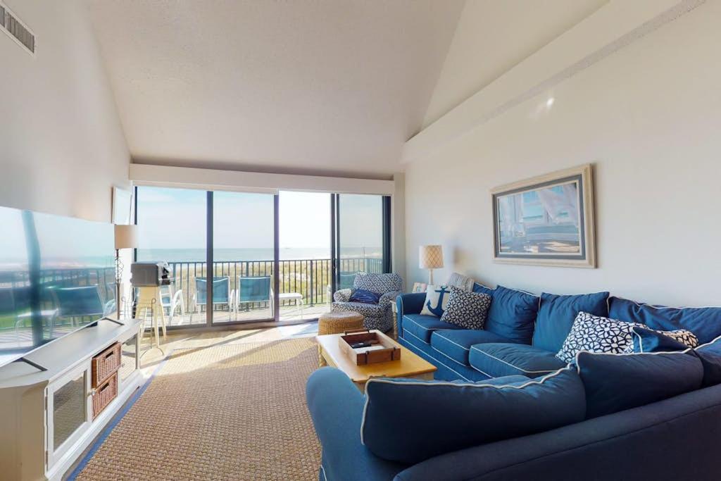 a living room with a blue couch and a tv at Sea Colony - 2F Brandywine Garden Rd in Bethany Beach