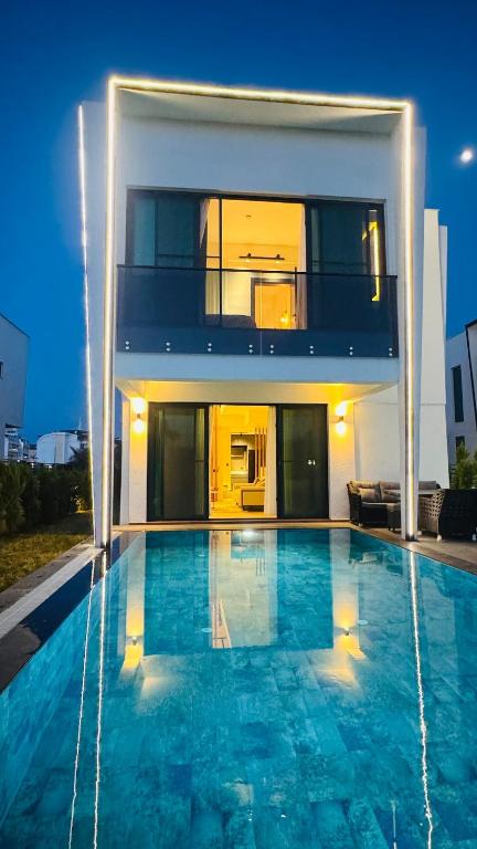 a large swimming pool in front of a house at Villa Marcy in Belek