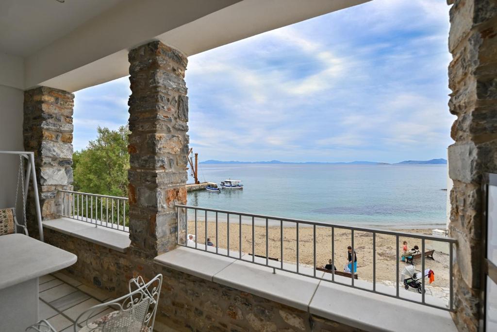 a view of the beach from the balcony of a house at Moutsouna Seaside in Moutsoúna