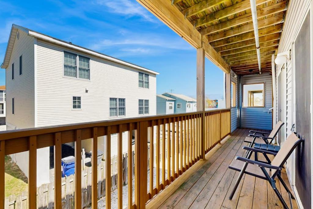 a deck with two chairs and a house at Rainbow Cove --- 117 Dagsworthy Ave #B in Dewey Beach