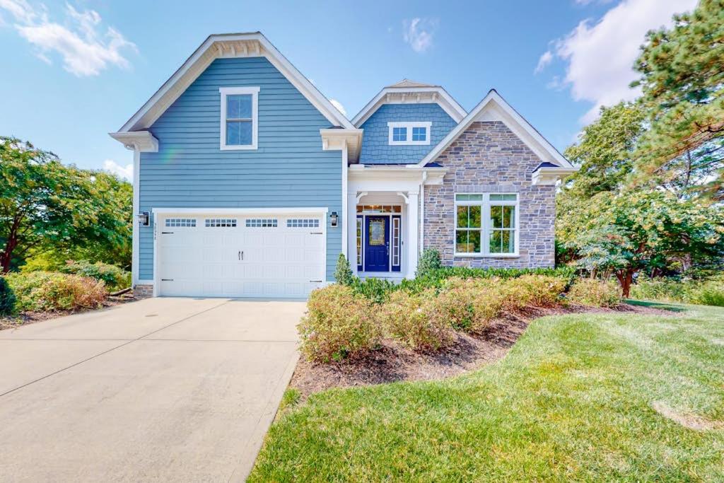 a blue house with a garage at Bayside Resort --- 38958 Aster Way in Selbyville