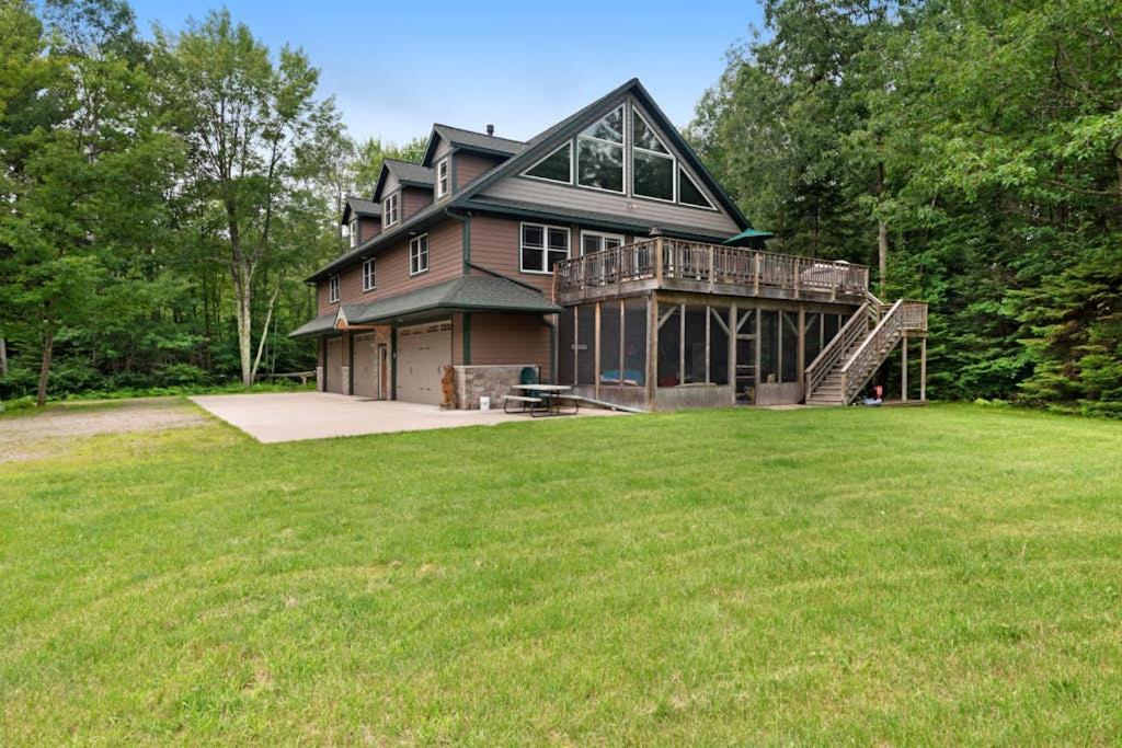 a large house with a large lawn in front of it at Grand Tomahawk Lodge in Tomahawk