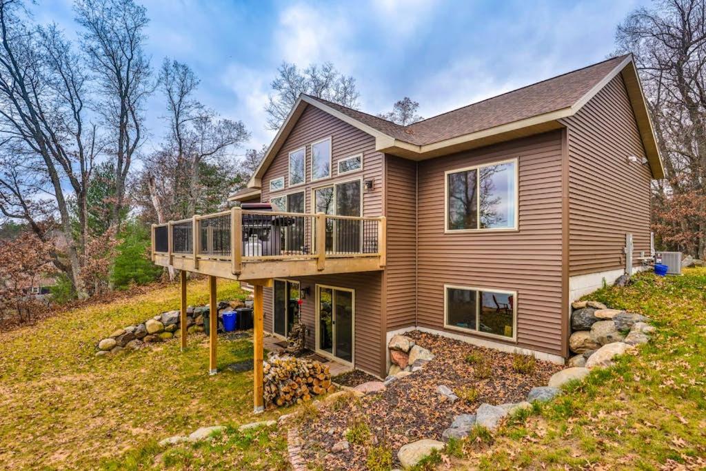 a house on a hill with a deck at A Place To Gather in Tomahawk