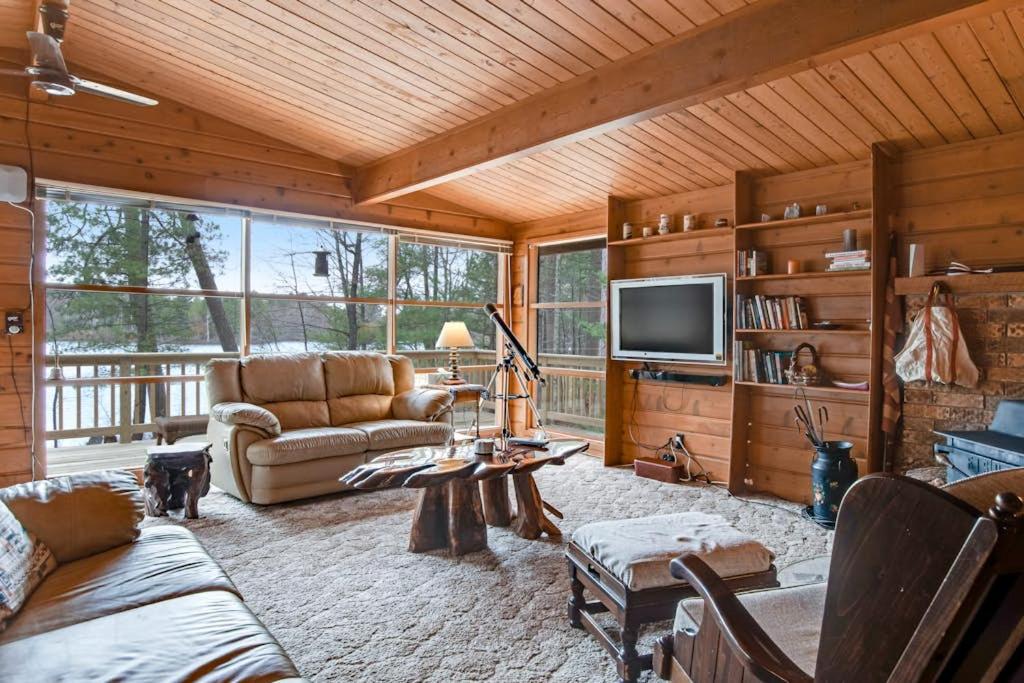 a living room with a couch and a tv at Lakeview North in Lac du Flambeau