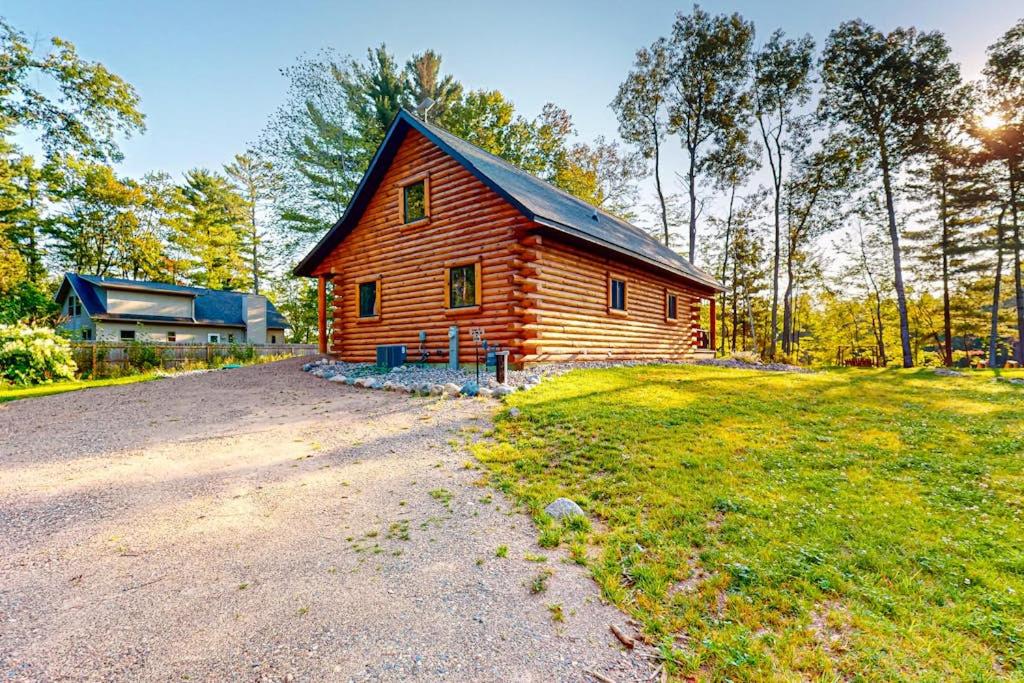 a log cabin in the middle of a field at Black Bear Cabin in Tomahawk