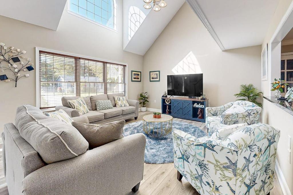 a living room with a couch and chairs and a tv at 112 Loganberry Lane in Rehoboth Beach