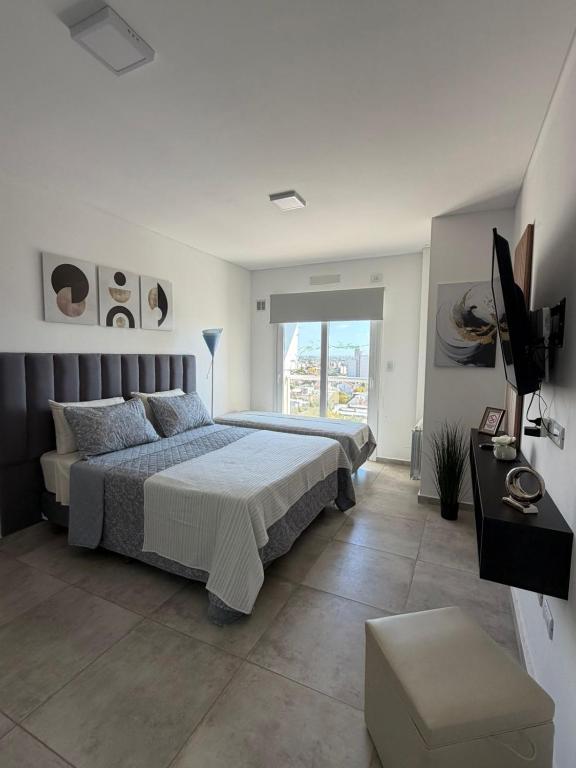 a bedroom with a bed and a television in it at Bienestar Studio in Bahía Blanca